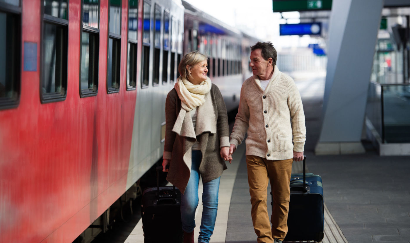 People_Retired-couple-traveling-at-train-station_Full